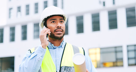 Image showing Civil engineer on a phone call while at a construction site discussing a strategy and plan to work on. Close up portrait of confident architect talking with building in the background and copy space