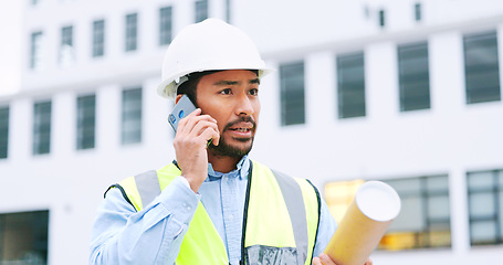 Image showing Civil engineer on a phone call while at a construction site discussing a strategy and plan to work on. Close up portrait of confident architect talking with building in the background and copy space