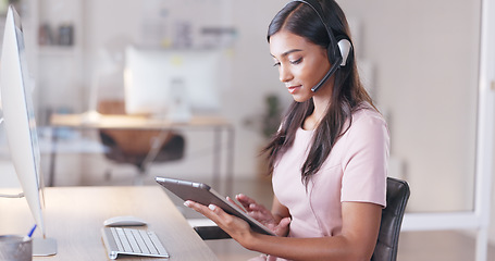 Image showing Young female customer service agent working in ecommerce and sales. Business woman working on a tablet in her office while helping and assisting customers online with IT support