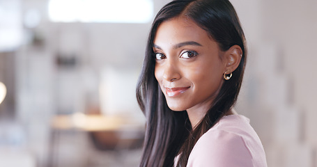 Image showing Trendy businesswoman looking happy and smiling while sitting in her office. Creative professional with a positive attitude and mindset feeling confident in her abilities and skills to achieve success