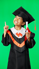 Image showing Graduation, education and child point on green screen for graduate, academy ceremony and award. Primary school, student and portrait of happy girl with knowledge, achievement and success in studio