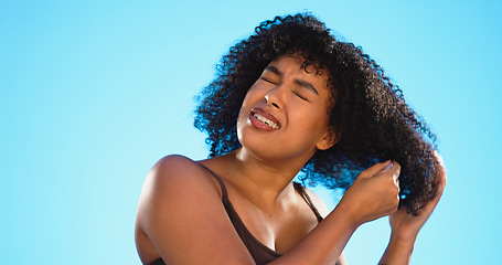 Image showing Afro, smile and black woman with comb for hair on blue background for wellness, cosmetics and health shine. Beauty salon, hairdresser and happy face of girl brushing for hairstyle, grooming and care