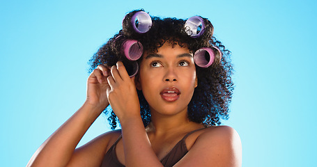 Image showing Black woman, hairstyle curlers and studio background with smile for beauty, self care and natural aesthetic. Happy gen z model, african girl and natural hair with happiness, plastic mould and soft