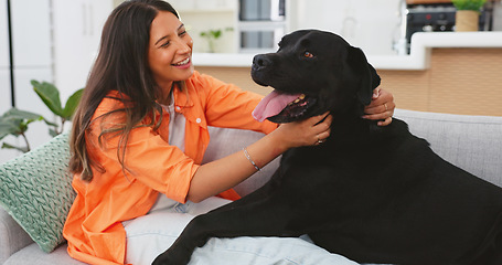 Image showing Happy woman relax with her dog on sofa for mental health, wellness or emotional support, love and care. Young person relaxing on living room couch and stroking puppy pet, animal or Labrador retriever