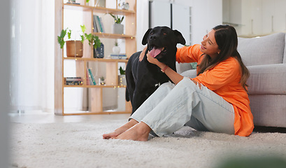 Image showing Woman, happiness and dog in a home with pet owner love, support and care feeling relax. Dogs scratch, young female and happy person sitting on a living room floor in a house with a smile and animal