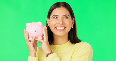 Image showing Happy woman, face and money savings on green screen for investment, budget or finance against studio background. Portrait of excited female holding piggybank for coin, profit or investing on mockup