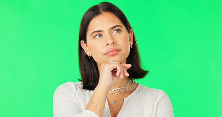 Image showing Face, idea and decision with a woman on a green screen background in studio to consider an option. Thinking, mind and contemplating with an attractive young female looking thoughtful on chromakey