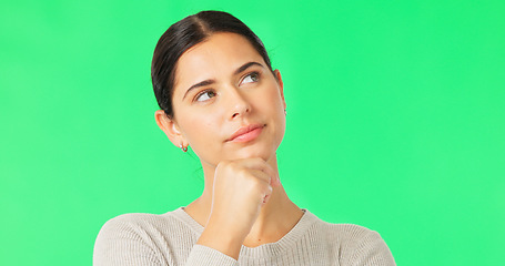 Image showing Face, idea and option with a woman on a green screen background in studio to consider a decision. Thinking, mind and contemplating with an attractive young female looking thoughtful on chromakey