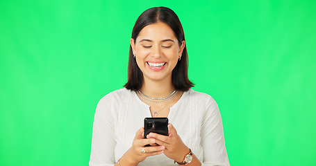 Image showing Happy woman, smartphone and typing on green screen, studio and social media post of funny meme online. Female model, laughing and texting on cellphone, download mobile games or search digital contact