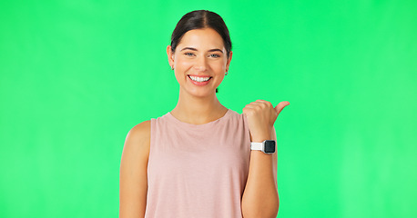 Image showing Woman face, pointing gesture and green screen with happiness and smile showing advertisement. Portrait, isolated and studio background with a happy young female point to show mock up announcement