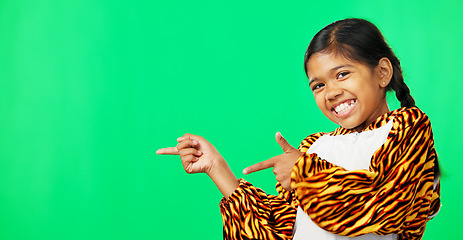 Image showing Showing, product placement and face of a child on a green screen isolated on a studio background. Laughing, happy and a portrait of a young girl pointing to mockup space for branding and advertising