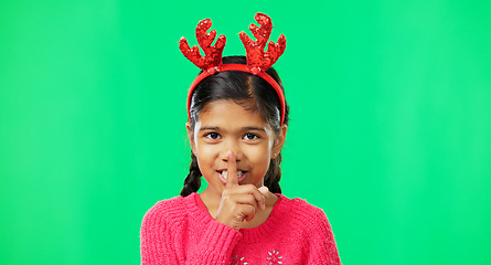 Image showing Shush, Christmas and secret with girl in green screen studio for holiday, gossip and gift. Surprise, festive and announcement with child isolated in background for celebration, privacy and present