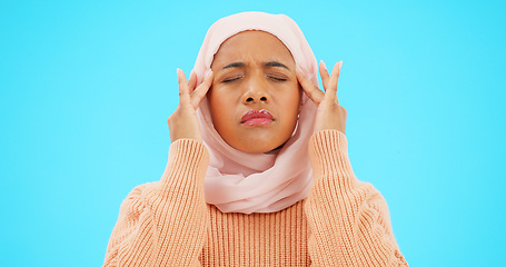 Image showing Muslim woman, headache and pain in studio for depression, stress and burnout. Islamic female with hands on head for a massage or mental health in a hijab while depressed, sick and fatigue or anxiety
