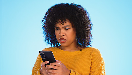 Image showing Angry, smartphone and black woman shouting, stress and social media with girl against a blue studio background. African American female, moody lady and cellphone with connection, upset and screaming