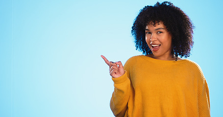 Image showing Mock up, studio dance and woman point at sales promotion, present gift or discount deal mockup. Dancing, advertising space or marketing product placement with happy African girl on blue background