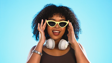 Image showing Trendy black woman face isolated on blue background for beauty, cosmetics and fashion of gen z lifestyle. Confident african american person or model with cool sunglasses and headphones for summer