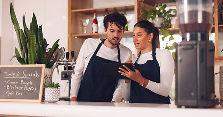 Image showing Barista team, talking with tablet in coffee shop, man and woman, discussion about work schedule or inventory check. Communication, technology with online system in cafe, working and manage sales