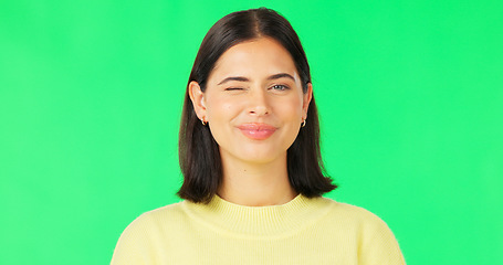 Image showing Happy, woman and face wink on green screen, studio and color background. Portrait, female model and winking with smile of cool girl, fun mood and joyful personality in happiness, emoji and flirting