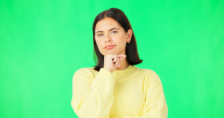 Image showing Face, thinking and consider with a woman on a green screen background in studio to decide her options. Idea, mind and contemplating with an attractive young female looking thoughtful on chromakey