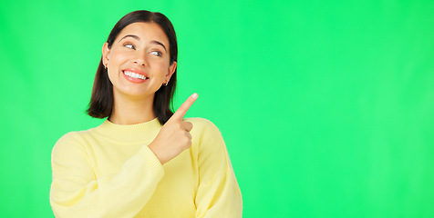 Image showing Portrait, pointing and product placement with a woman on green screen in studio for marketing or advertising. Hand gesture, product placement and options with an attractive young female on chromakey