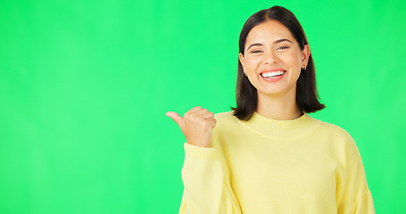 Image showing Portrait, pointing and branding with a woman on green screen space in studio for marketing or product placement. Hand gesture, advertising and options with an attractive young female on chromakey