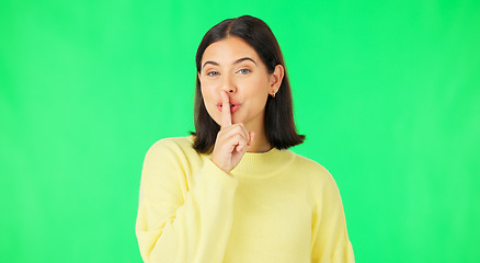 Image showing Green screen, happy face and secret woman with finger on lips, wink and privacy in studio. Portrait of female model, silence and shush for quiet, gossip and whisper emoji for confidential surprise