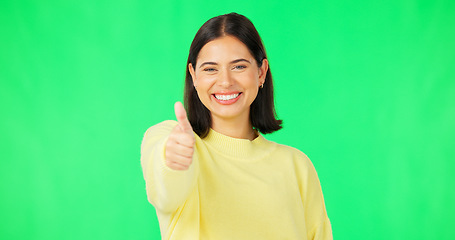 Image showing Happy woman, thumbs up and green screen for winning, success or agreement against a studio background. Portrait of female face with smile showing thumb emoji, yes sign or like on chromakey mockup