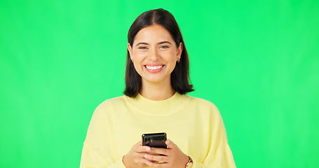 Image showing Smile, woman and smartphone on green screen, face and studio for social media, online contact and meme. Portrait of happy female model typing on cellphone, download mobile games or scroll for texting