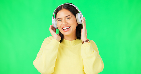 Image showing Face, green screen and woman with headphones, listen and movement on a studio background. Portrait, female dancer and person with headset, streaming music and excitement with stress relief and relax