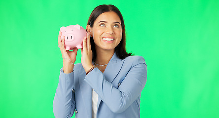Image showing Business woman, money and savings on green screen for investment, budget or finance against studio background. Portrait of happy female smile holding piggybank for coin, profit or investing on mockup