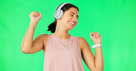 Image showing Headphones, happy woman and dancing to music on green screen, studio and backdrop. Dance, female model and listening to audio album, streaming media and sound of radio, subscription podcast or energy
