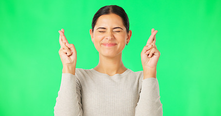 Image showing Excited woman, fingers crossed and face on green screen, background and studio for good luck. Portrait of happy female model hope for winning prize, wish and optimism with emoji sign, hands and smile