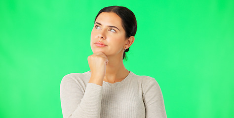 Image showing Face, thinking and option with a woman on a green screen background in studio to consider a decision. Idea, mind and contemplating with an attractive young female looking thoughtful on chromakey