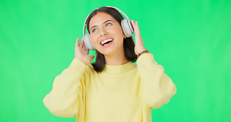 Image showing Face, green screen and woman with headphones, listen and movement on a studio background. Portrait, female dancer and person with headset, streaming music and excitement with stress relief and relax