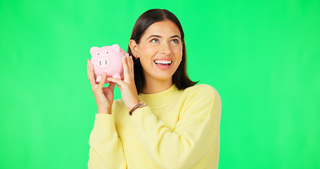 Image showing Happy woman, money and savings on green screen for investment, budget or finance against studio background. Portrait of excited female smile holding piggybank for coin, profit or investing on mockup