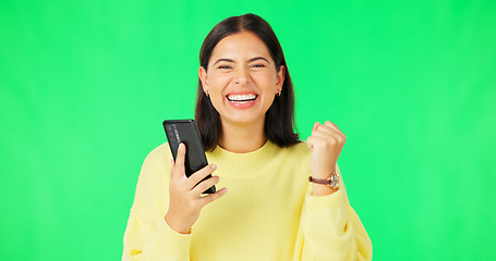 Image showing Happy woman, phone and celebration on green screen for winning, promotion or bonus against a studio background. Portrait of excited female in joyful happiness on smartphone for win or prize on mockup