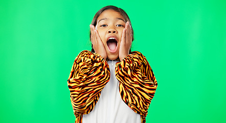 Image showing Girl child, shock face and green screen studio with tiger pyjamas, costume and wow with hands on face. Female kid, surprise facial expression and mock up portrait for news with space by background