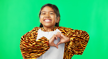 Image showing Heart, green screen and love hand sign by kid excited, smile and excited isolated in studio background. Young, care and support gesture by girl or kid in tiger costume showing symbol or shape