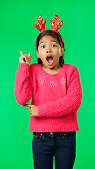 Image showing Christmas, antlers and idea with a girl on a green screen background in studio looking surprised. Children, portrait and eureka with an adorable little female child having an aha moment on chromakey