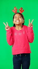 Image showing Girl child, peace sign and face by green screen studio in christmas mockup, reindeer costume or happiness. Emoji hands, kid and vertical portrait for holiday, festive cheer or happy childhood memory