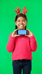 Image showing Christmas face, green screen and kid with phone in studio isolated on a background with tracking markers. Mockup, xmas and smile of happy girl with mobile smartphone for marketing or advertising.