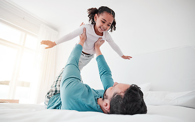 Image showing Fun, playing and a dad holding a child, bonding and pretending to fly in a bedroom. Happy, playful and a little girl flying, feeling free and spending quality time with a father for play at home