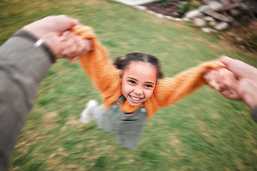 Image showing Blur, happy and a child and father swinging, playing and bonding in the garden. Smile, playful and a little girl moving with energy during playtime with dad holding hands to swing in the backyard