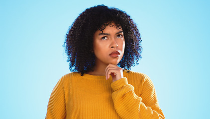 Image showing Confused, face and thinking by black woman in studio, pensive and wondering on blue background. Doubt, portrait and unsure girl with decision, choice or emoji on mockup, product placement or isolated