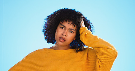 Image showing Face, confused and thinking by black woman in studio, pensive and wondering on blue background. Doubt, portrait and unsure girl with decision, choice or emoji on mockup, product placement or isolated