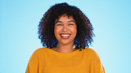 Image showing Happy black woman, face and beauty in studio by blue background for fashion, smile and wellness. Young gen z student, portrait and happy with yellow clothes, curly hair afro and confident by backdrop