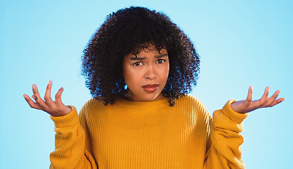 Image showing Face, confused and unsure black woman in studio, pensive and dont know gesture on blue background. Doubt, portrait and girl with decision, why or emoji on mockup, product placement or isolated