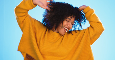 Image showing Happy black woman, dance and beauty in studio by blue background for fashion, smile or wellness. Young gen z student, dancing and freedom with yellow clothes, curly hair afro and fitness by backdrop