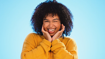 Image showing Face, celebration and black woman excited, smile and success with girl on a blue studio background. Portrait, African American female and lady with happiness, winning and victory with joy or cheerful