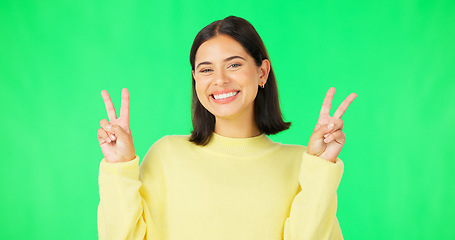 Image showing Green screen, funny face expression and happy woman posing with tongue out, peace sign and carefree personality. Portrait, female model and smile in studio with emoji reactions, meme and happiness